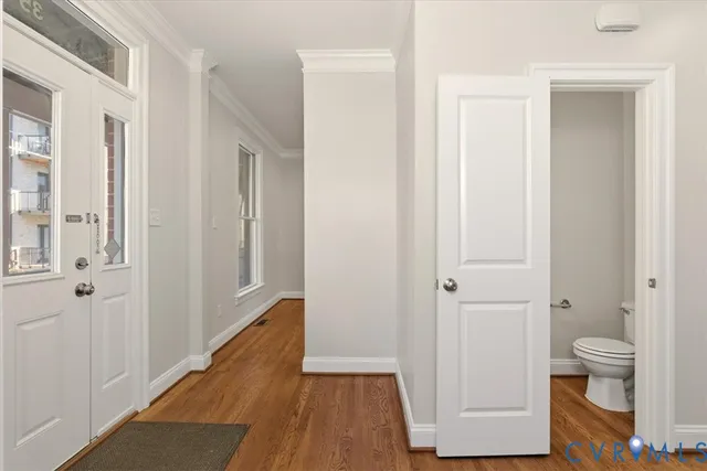 a view of bathroom with a toilet a mirror and a shower