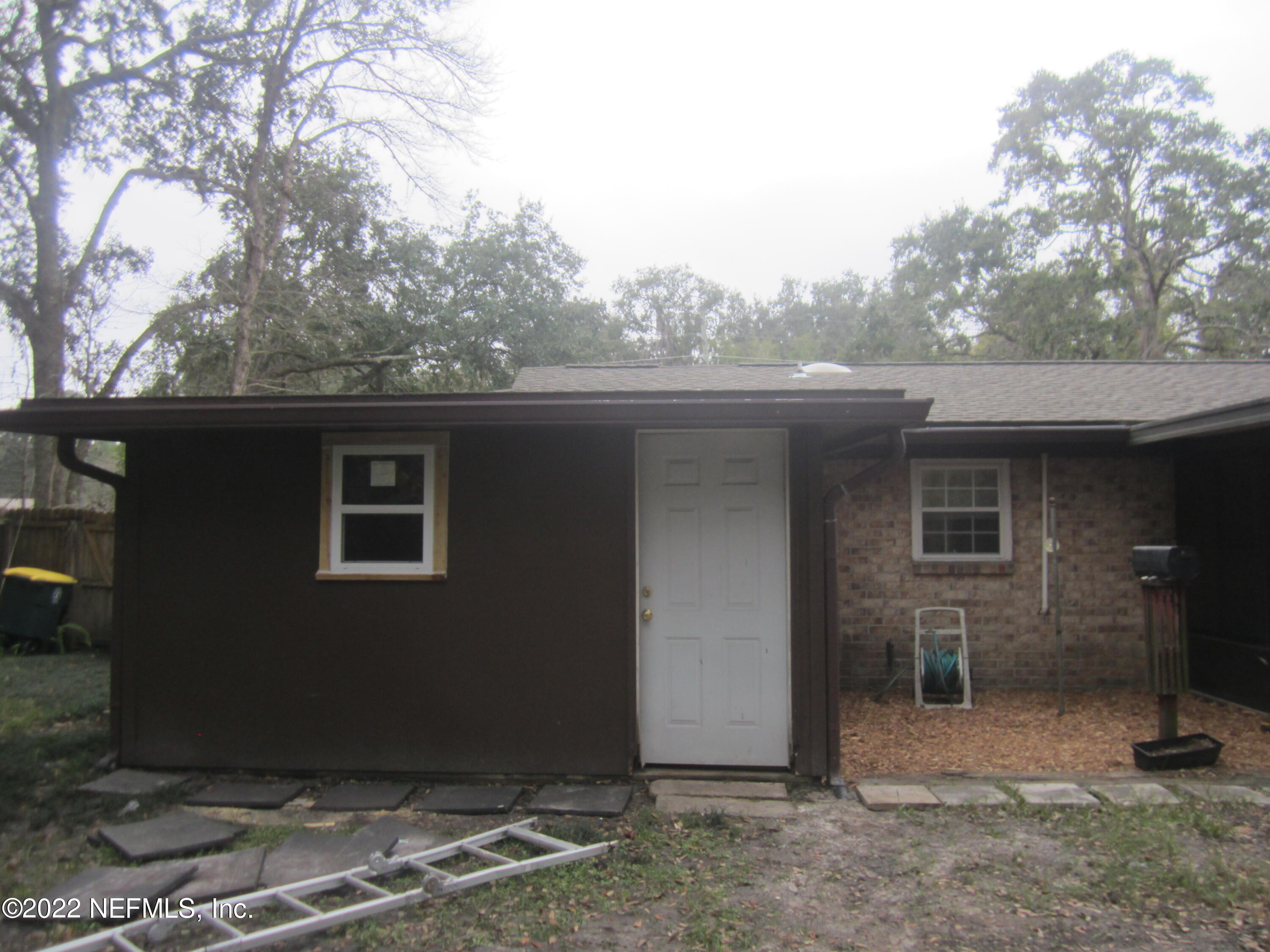 13005 Mandarin Road Jacksonville, FL 32223 - Photo 43 of 51 a backyard of a house with large trees and a barn