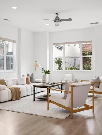 a living room with furniture a window and a table