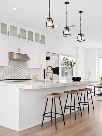 a kitchen with a table chairs and white cabinets