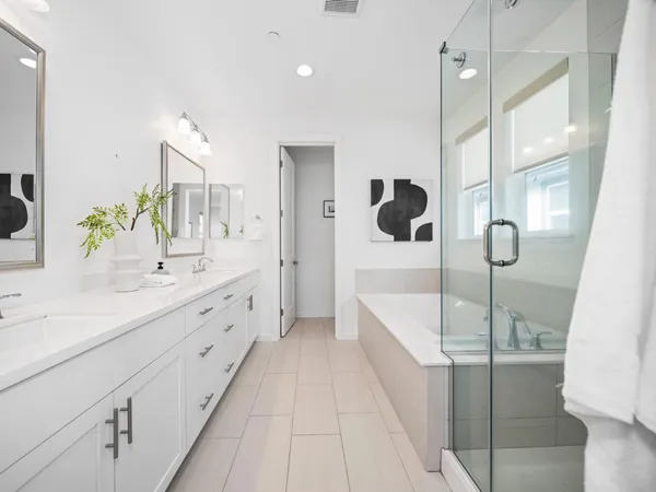 a bathroom with a tub sink and mirror