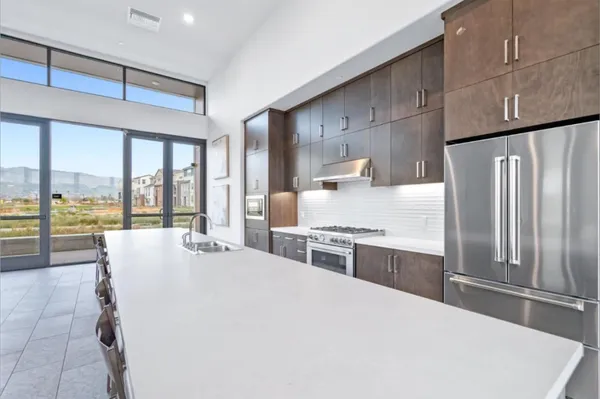 a large white kitchen with a large window