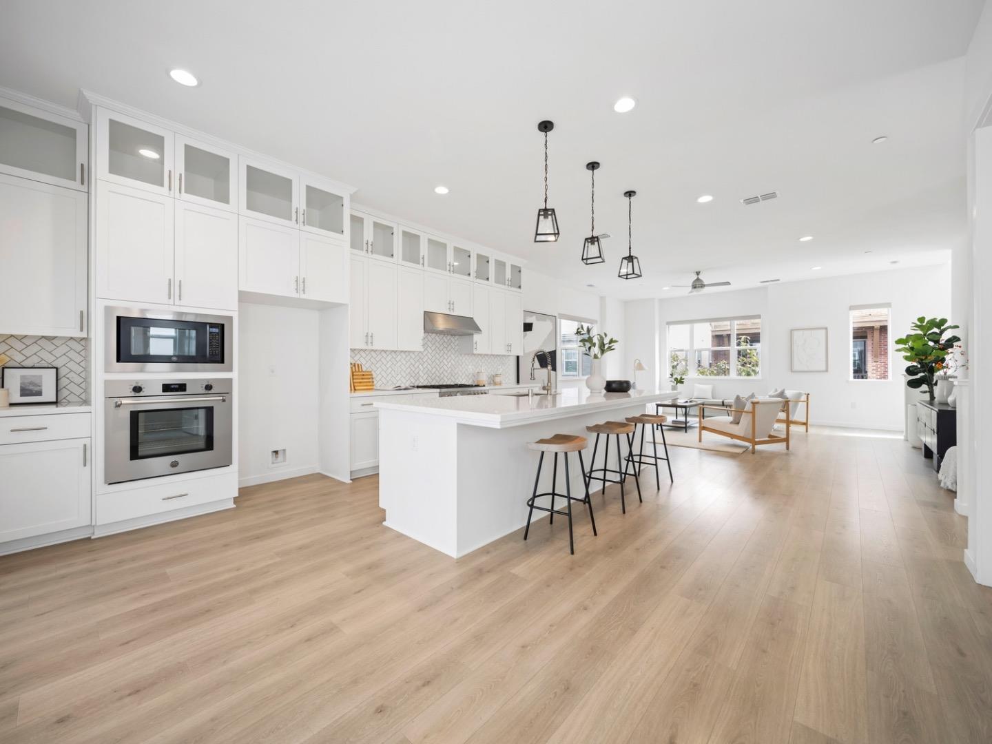 2149 Pastoral Loop San Jose, CA 95122 - Photo 9 of 46 a large white kitchen with lots of counter space wooden floor and appliances