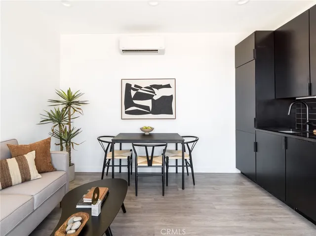 a living room with furniture wooden floor and a flat screen tv