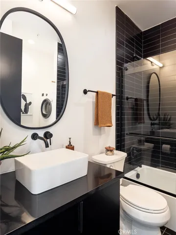 a bathroom with a sink toilet and mirror