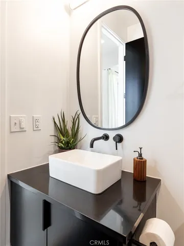 a bathroom with a sink a mirror and a toilet
