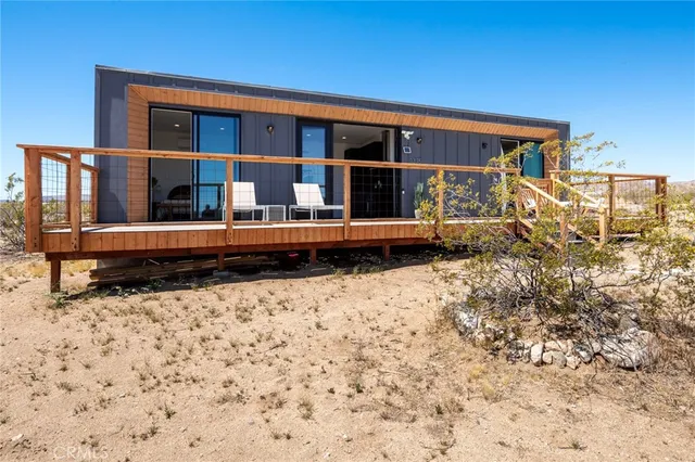 a view of a balcony with wooden floor and outdoor seating