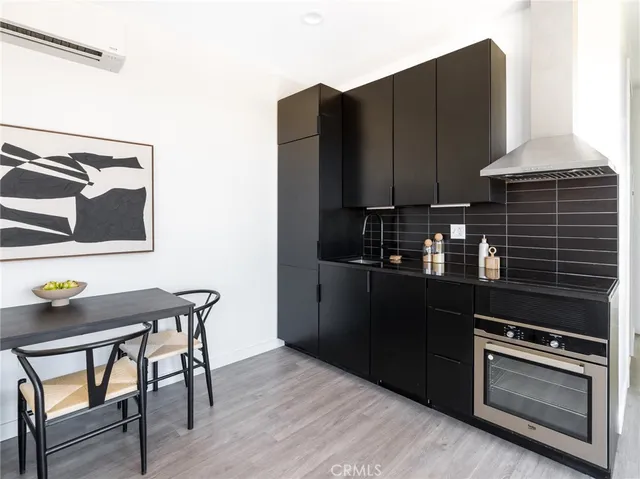 a kitchen with granite countertop a stove and wooden cabinets