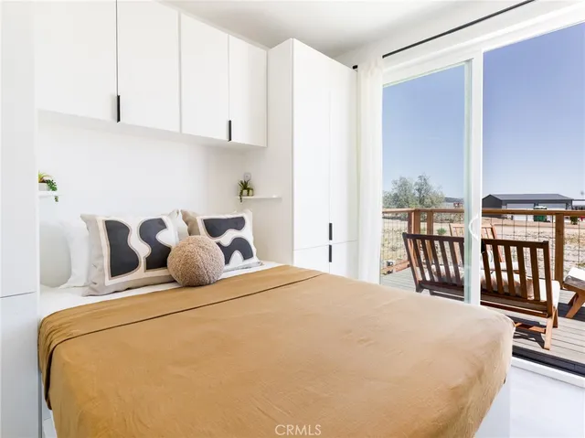 a large bed sitting in a bedroom next to a window