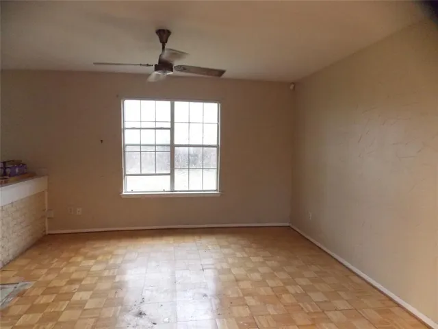 a view of room with a ceiling fan and window