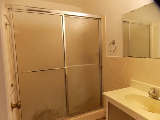 a bathroom with a shower and a sink