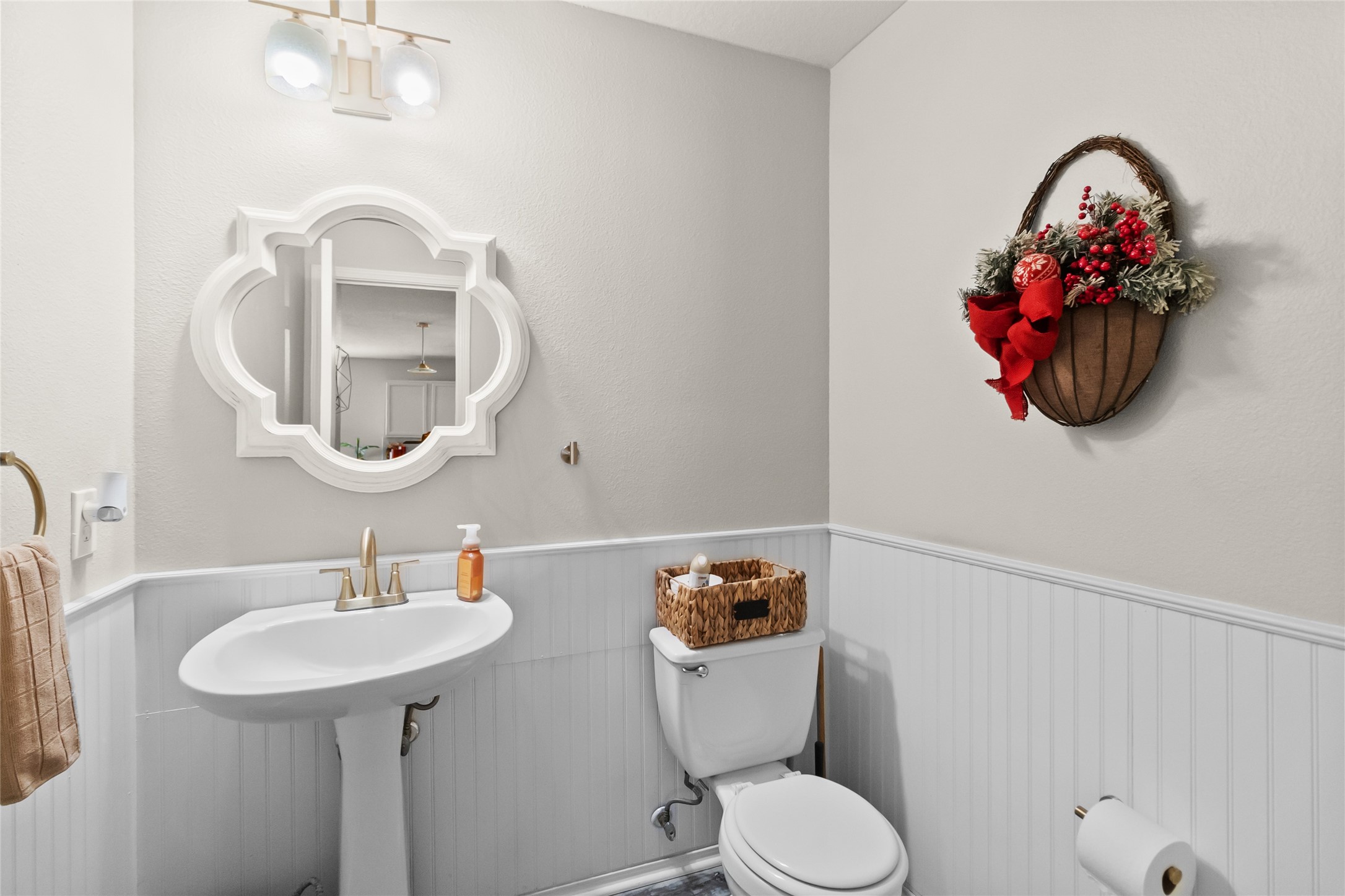 615 Ashlen Drive Houston, TX 77073 - Photo 19 of 35 Your half bath is clean, bright, and thoughtfully finished with beadboard detailing and a pedestal sink that keeps the space feeling open. Neutral tones and updated lighting make it a simple, polished spot that’s perfect for guests.