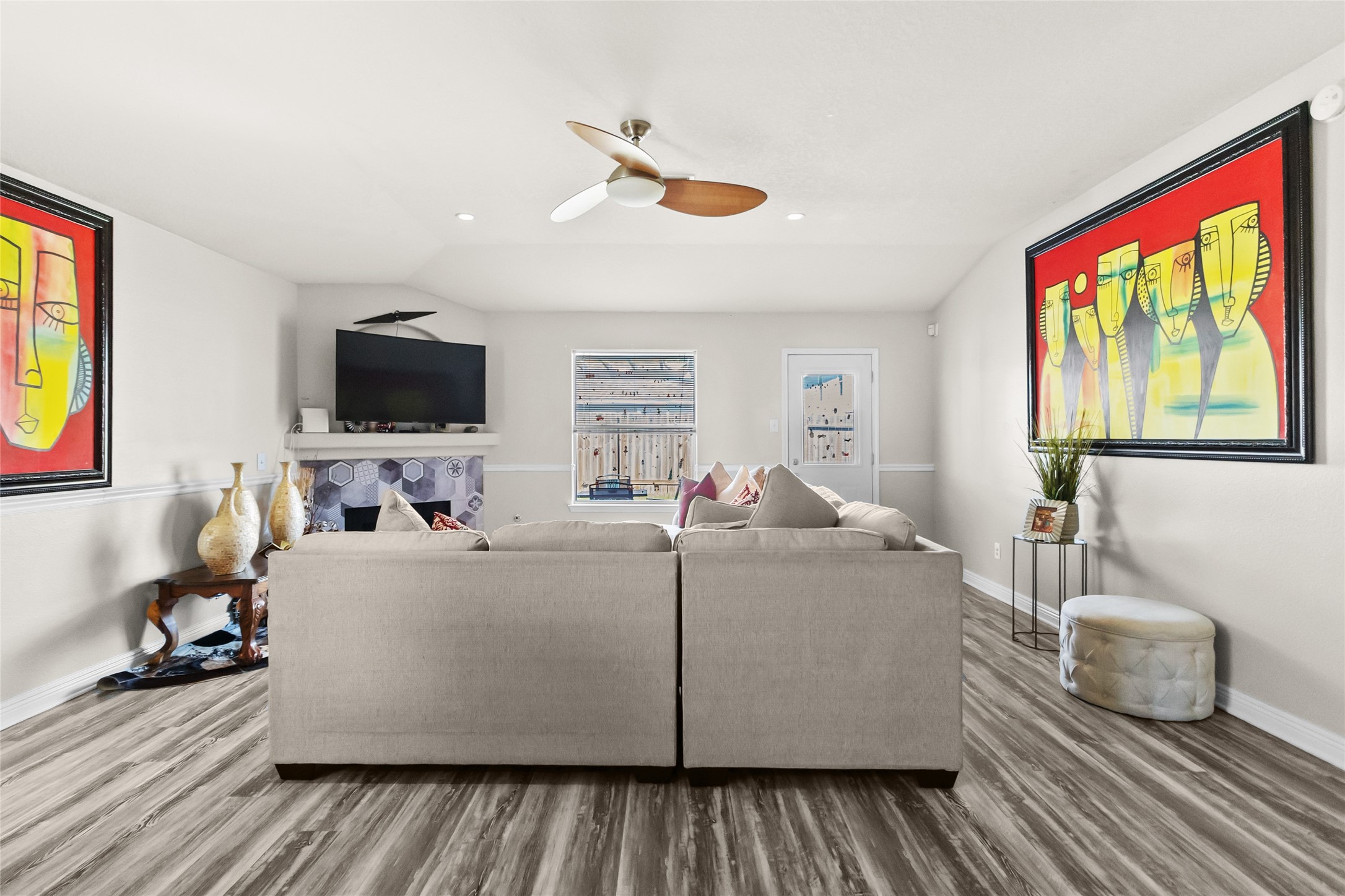 615 Ashlen Drive Houston, TX 77073 - Photo 24 of 35 This open living room gives you flexibility to arrange seating exactly how you like it, with plenty of room for entertaining or relaxing. Clean lines, neutral walls, and bold artwork create a space that feels both modern and inviting. The open sightlines make it easy to stay connected to the dining area and kitchen while hosting.