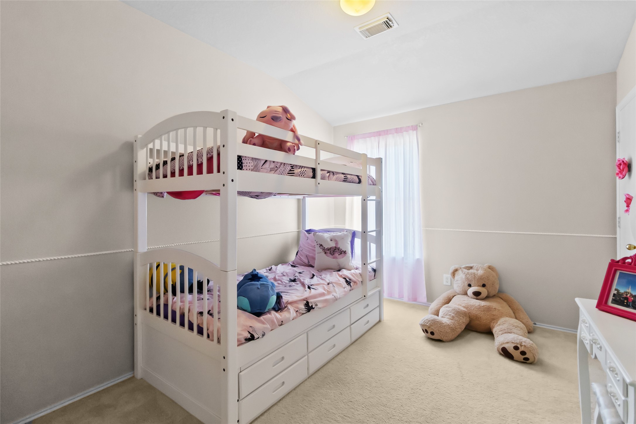 615 Ashlen Drive Houston, TX 77073 - Photo 26 of 35 This room is clearly ready for fun—bunk beds for sleepovers, built-in storage underneath, and plenty of floor space left over for toys, playtime, or a reading corner. The soft light coming through the window keeps it bright without feeling harsh.