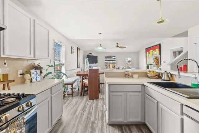 a kitchen with a sink stove and cabinets