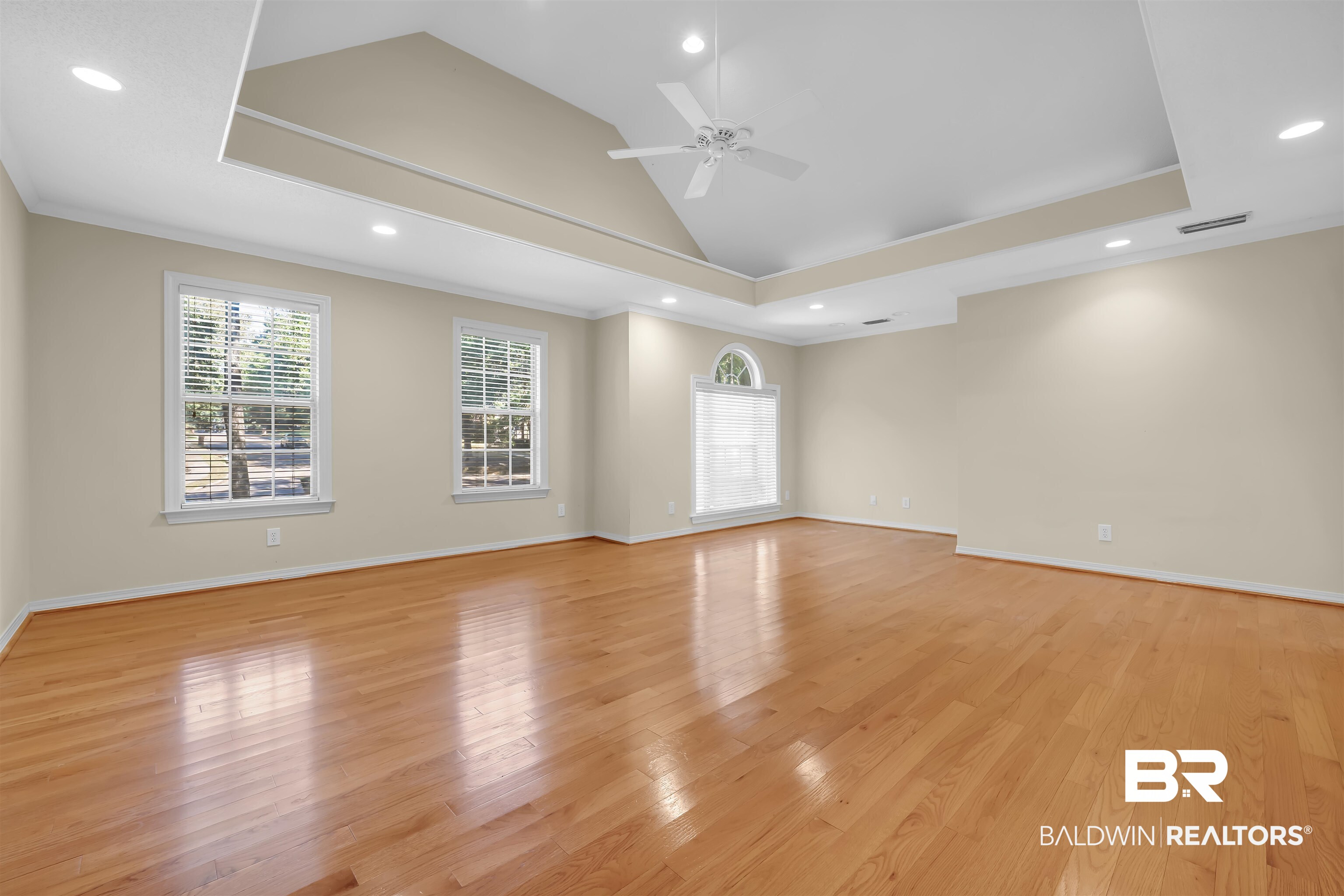 1262 Patrick Street Daphne, AL 36526 - Photo 28 of 35 Unfurnished room featuring crown molding, light wood-type flooring, healthy amount of natural light, recessed lighting, and vaulted ceiling