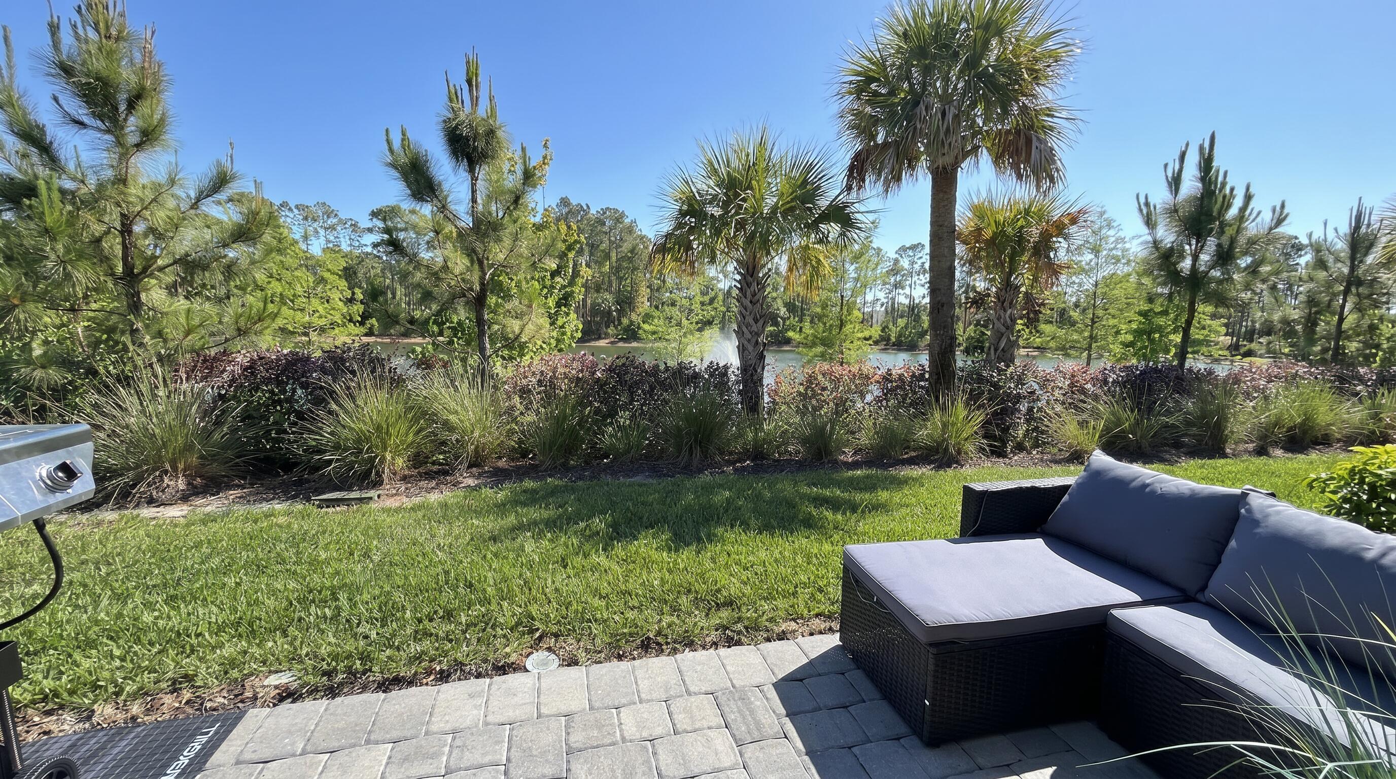 5784 Southeast Edgewater Circle Stuart, FL 34997 - Photo 8 of 33 a view of a sitting area with furniture and a garden