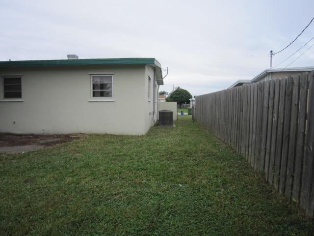 341 Shady Lane Road Palm Springs, FL 33461 - Photo 6 of 24 a backyard of a house with lots of green space