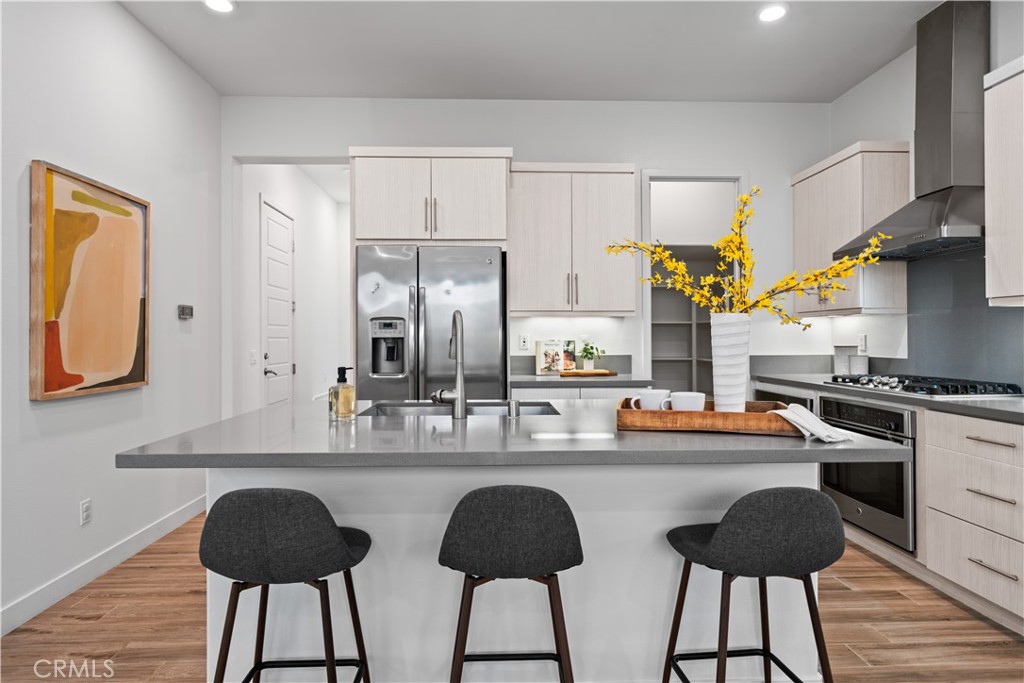 116 Newall Irvine, CA 92618 - Photo 11 of 45 a kitchen with stainless steel appliances a dining table chairs and a refrigerator