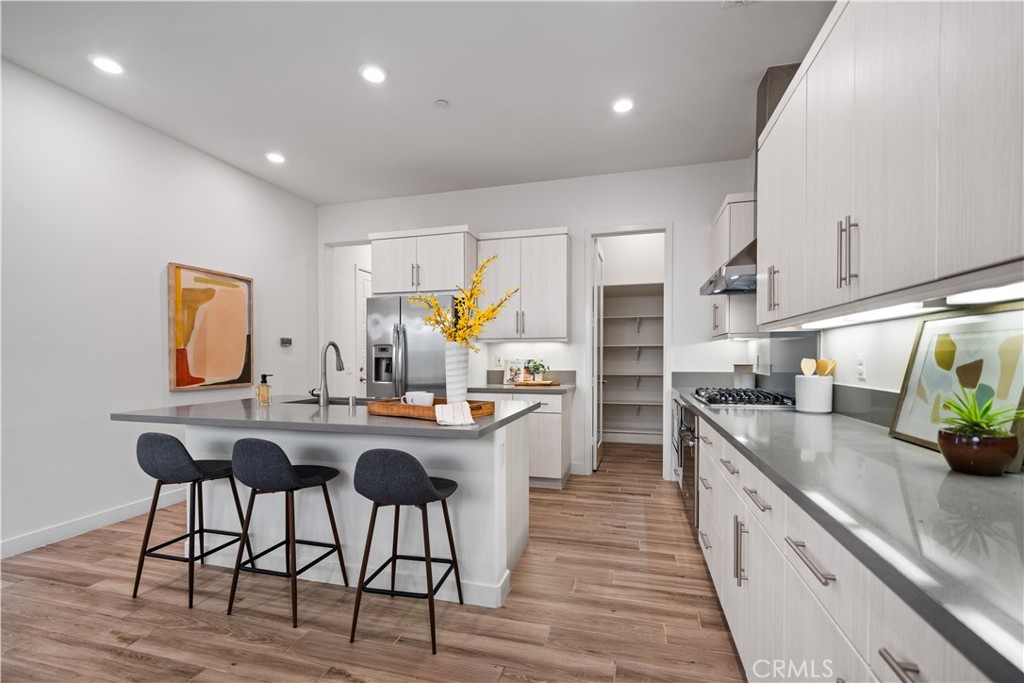116 Newall Irvine, CA 92618 - Photo 15 of 45 a kitchen with stainless steel appliances granite countertop a table chairs sink and cabinets