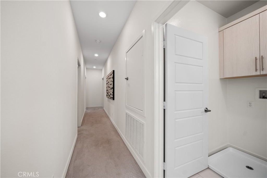 116 Newall Irvine, CA 92618 - Photo 18 of 45 a view of a hallway with white walls