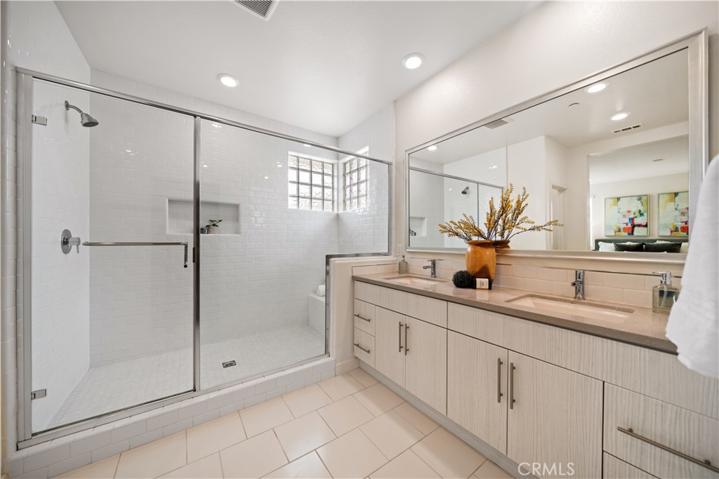 116 Newall Irvine, CA 92618 - Photo 31 of 45 a bathroom with a shower sink and mirror