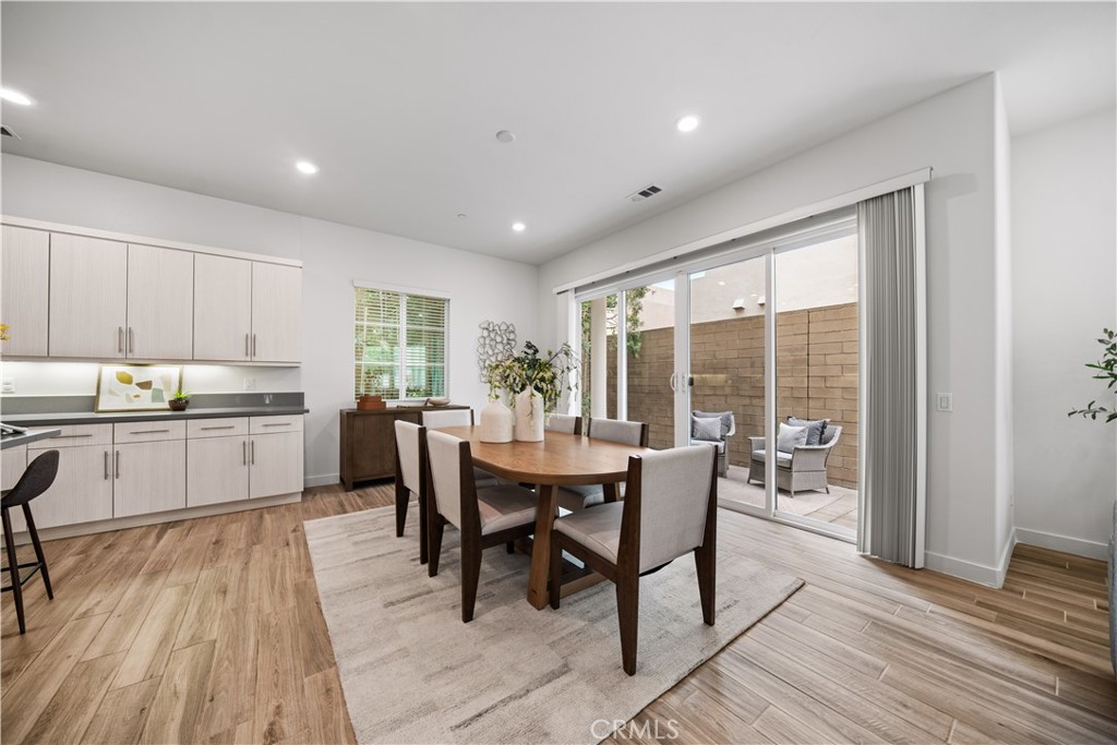 116 Newall Irvine, CA 92618 - Photo 7 of 45 a kitchen with a table chairs wooden floors and white stainless steel appliances