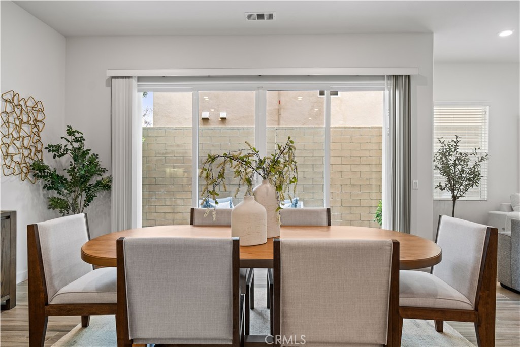 116 Newall Irvine, CA 92618 - Photo 8 of 45 a dining room with furniture and large windows