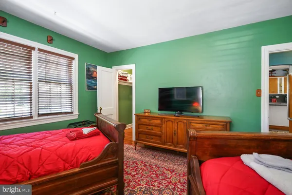 a bedroom with a bed and flat screen tv