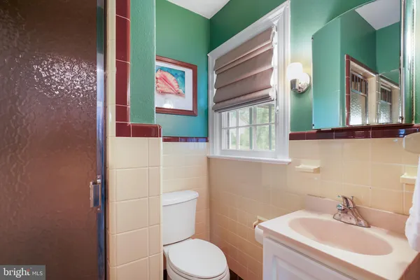 a bathroom with a toilet sink and mirror