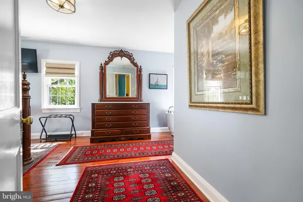 a hallway with a bed and a window with outer view