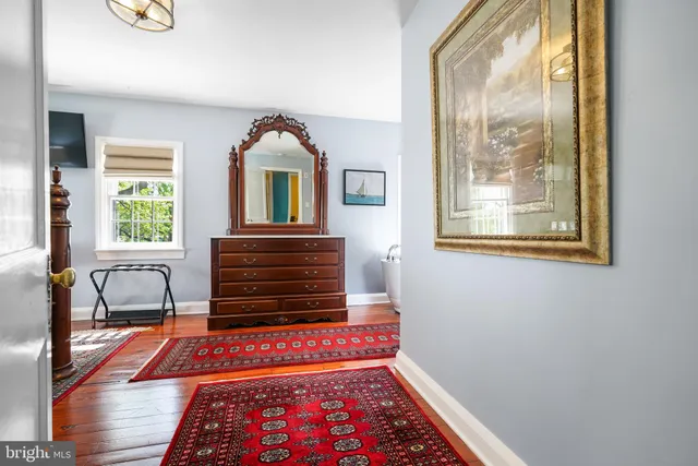 a hallway with a bed and a window with outer view