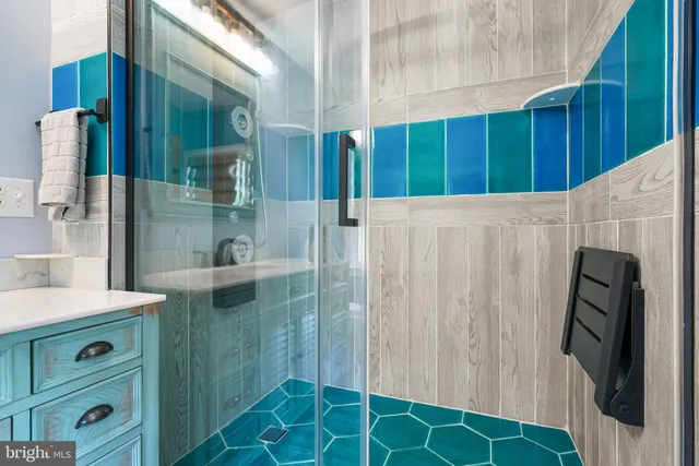 a bathroom with a sink a mirror and shower