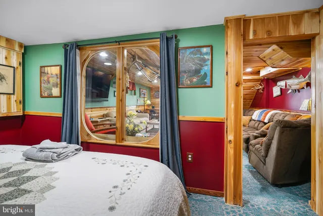 a bed room with a bed and a dresser with a large mirror