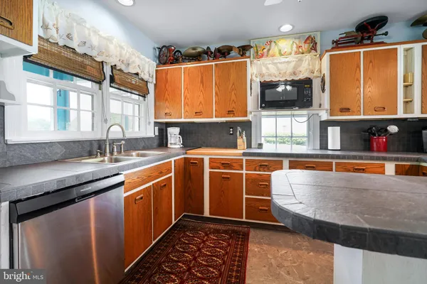 a kitchen with stainless steel appliances a sink and a microwave