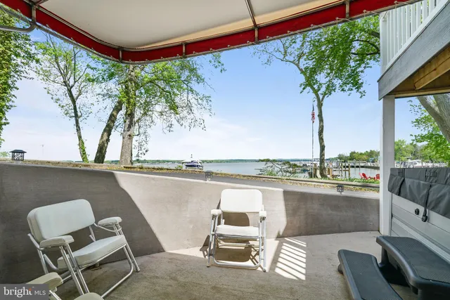 a view of a porch with furniture and a tree