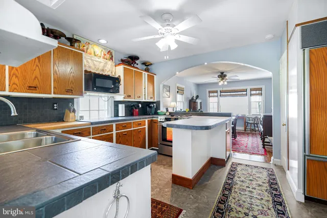 a kitchen with stainless steel appliances granite countertop a sink and a refrigerator