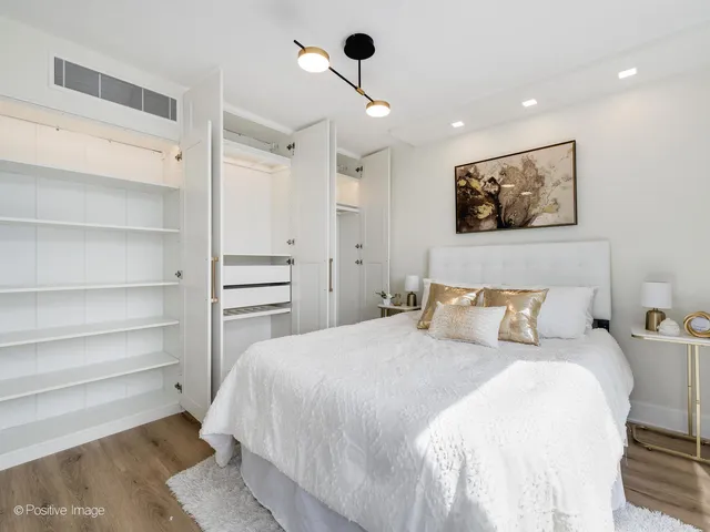 a bedroom with a bed and a painting on the wall