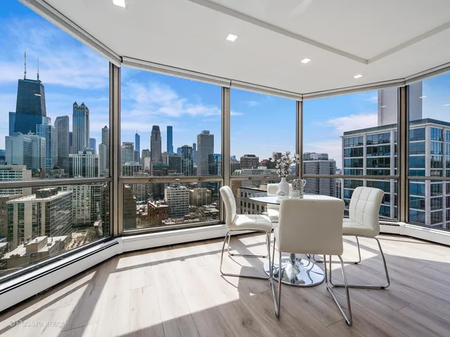 a dining room with furniture and wooden floor