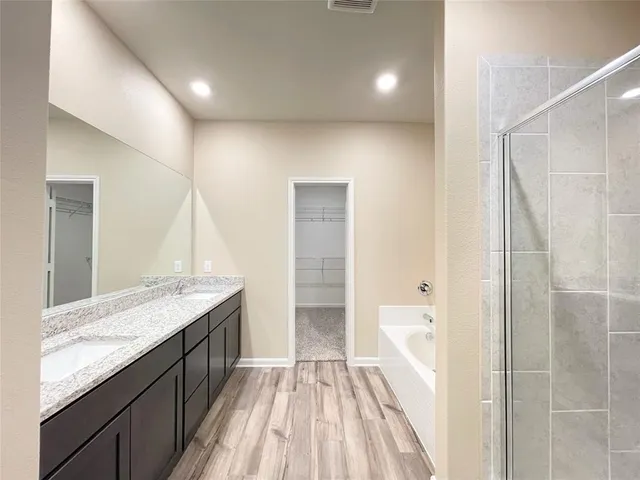 a bathroom with a granite countertop sink a toilet and shower