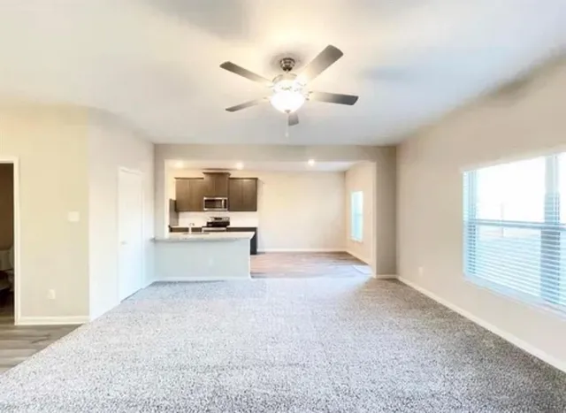 a view of a kitchen with a sink and a window