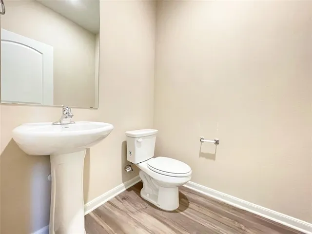 a bathroom with a sink toilet and a mirror
