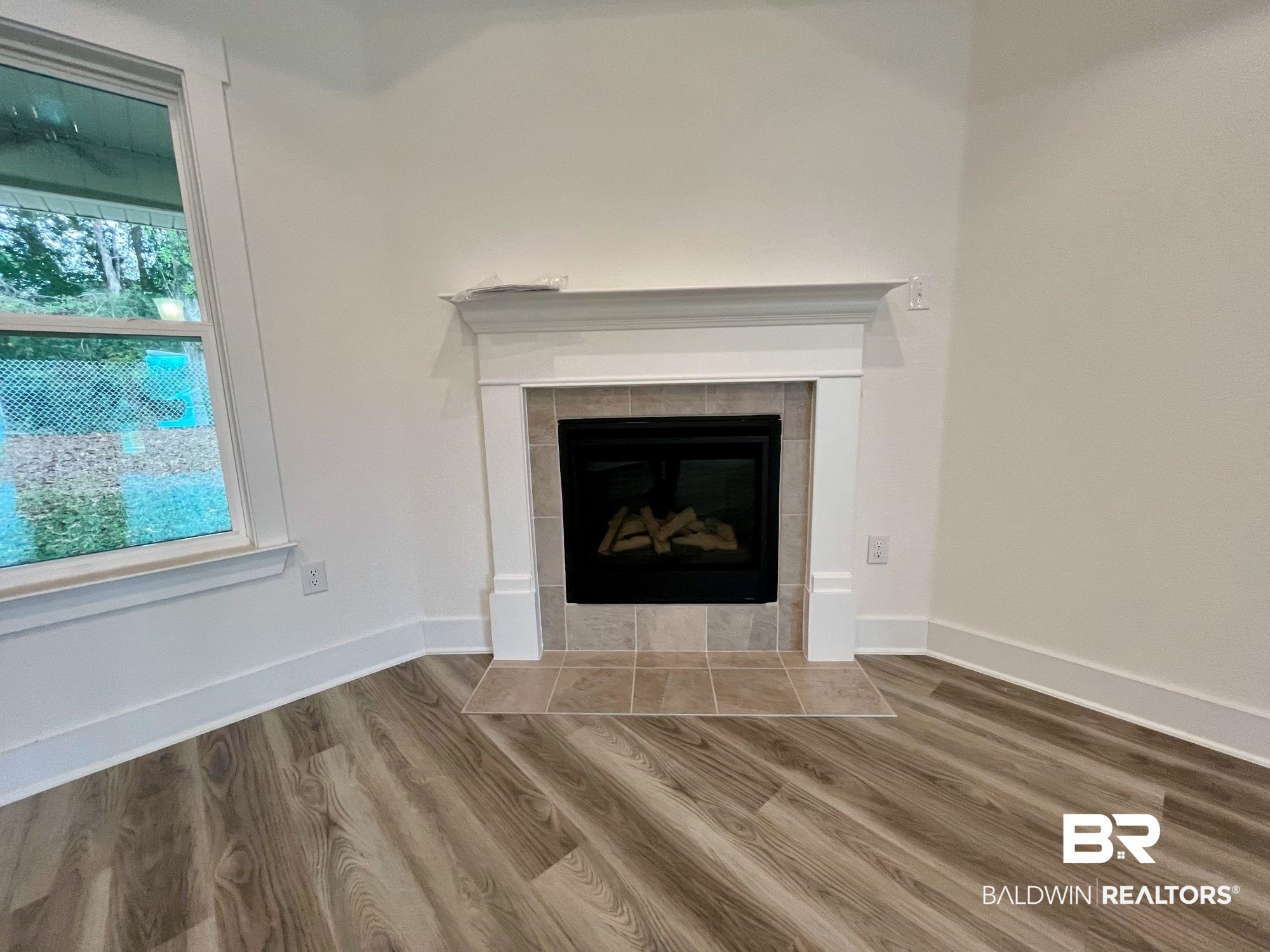 334 Barndling Street Fairhope, AL 36532 - Photo 11 of 34 Interior details featuring a tiled fireplace and wood-type flooring