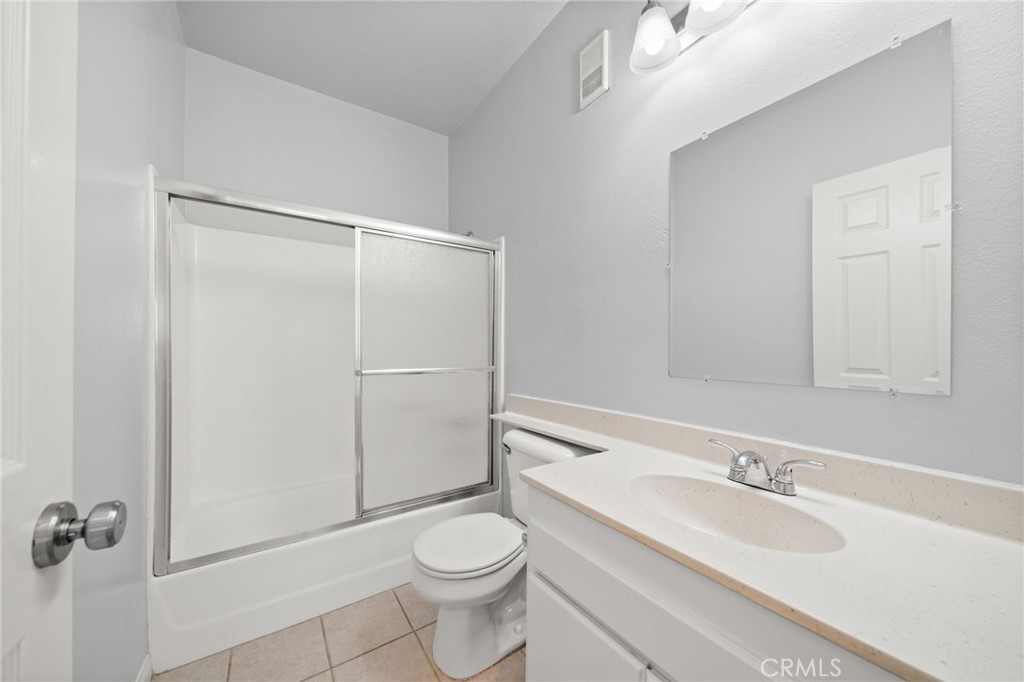 1145 Roswell Avenue, Unit 204 Long Beach, CA 90804 - Photo 11 of 14 a bathroom with a granite countertop sink toilet and shower