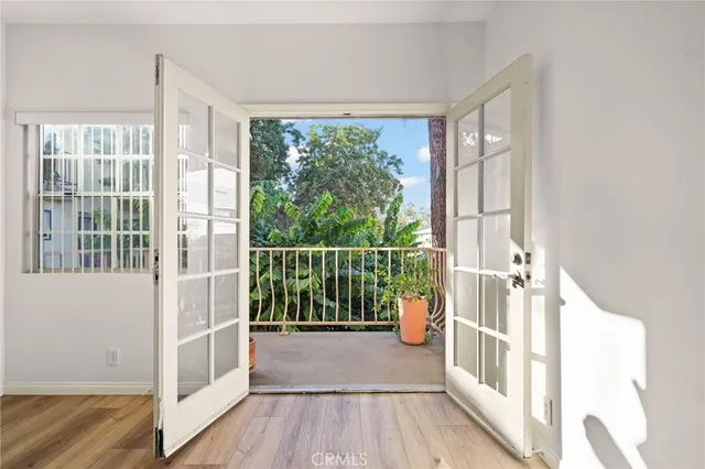 a view of a room with wooden floor and windows