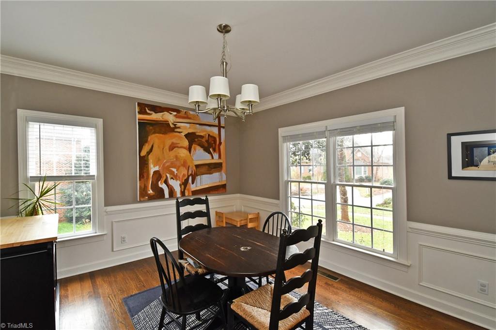 125 Windrush Road Winston-Salem, NC 27106 - Photo 4 of 23 Dining Room with Chair Rail, Picture Molding & Hardwood Floors
