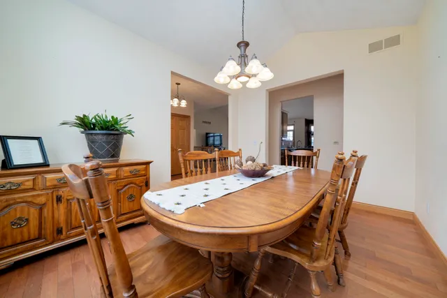 a view of a dining room with furniture and wooden floor