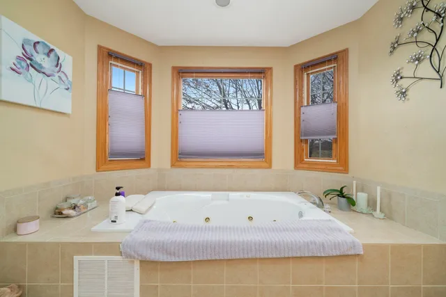 a bath tub sitting next to a bathroom sink