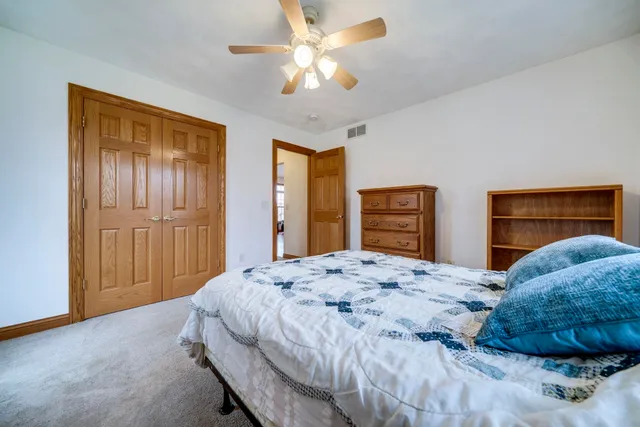 a bedroom with a bed and a dresser