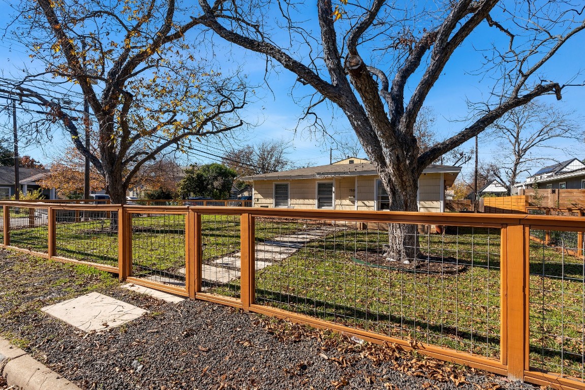 a front view of a house with wooden fence